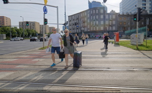 People crossing a busy street in Warsaw, Poland